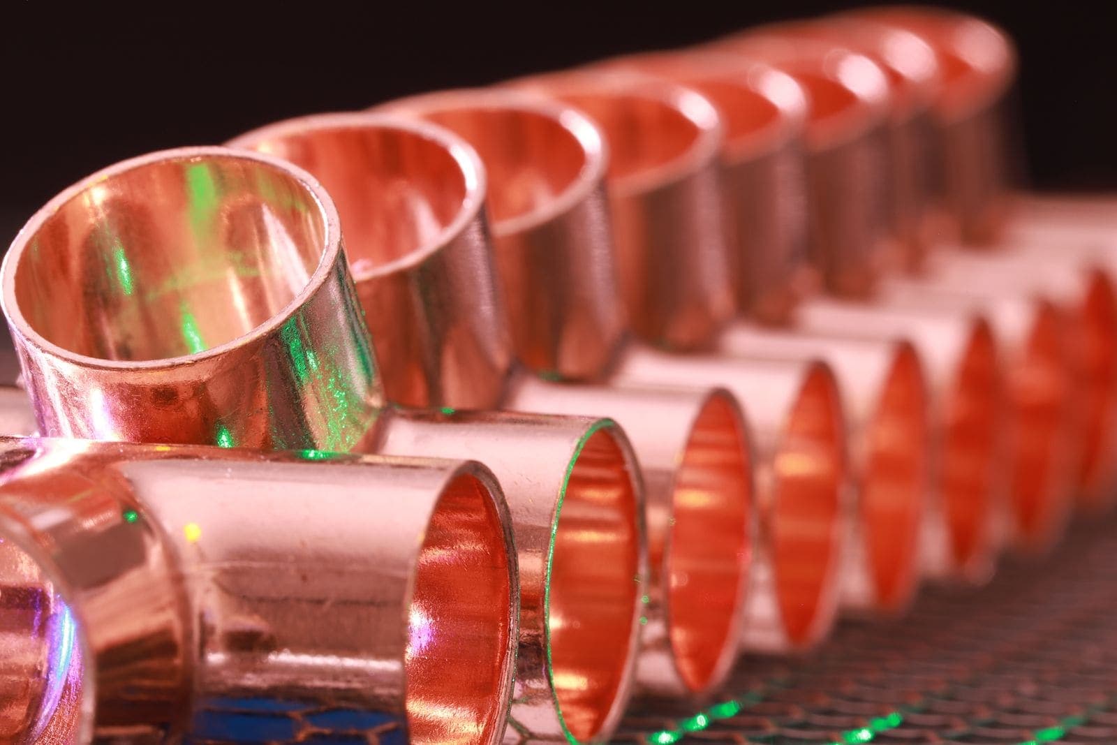 Copper pipe fittings lined up in a row