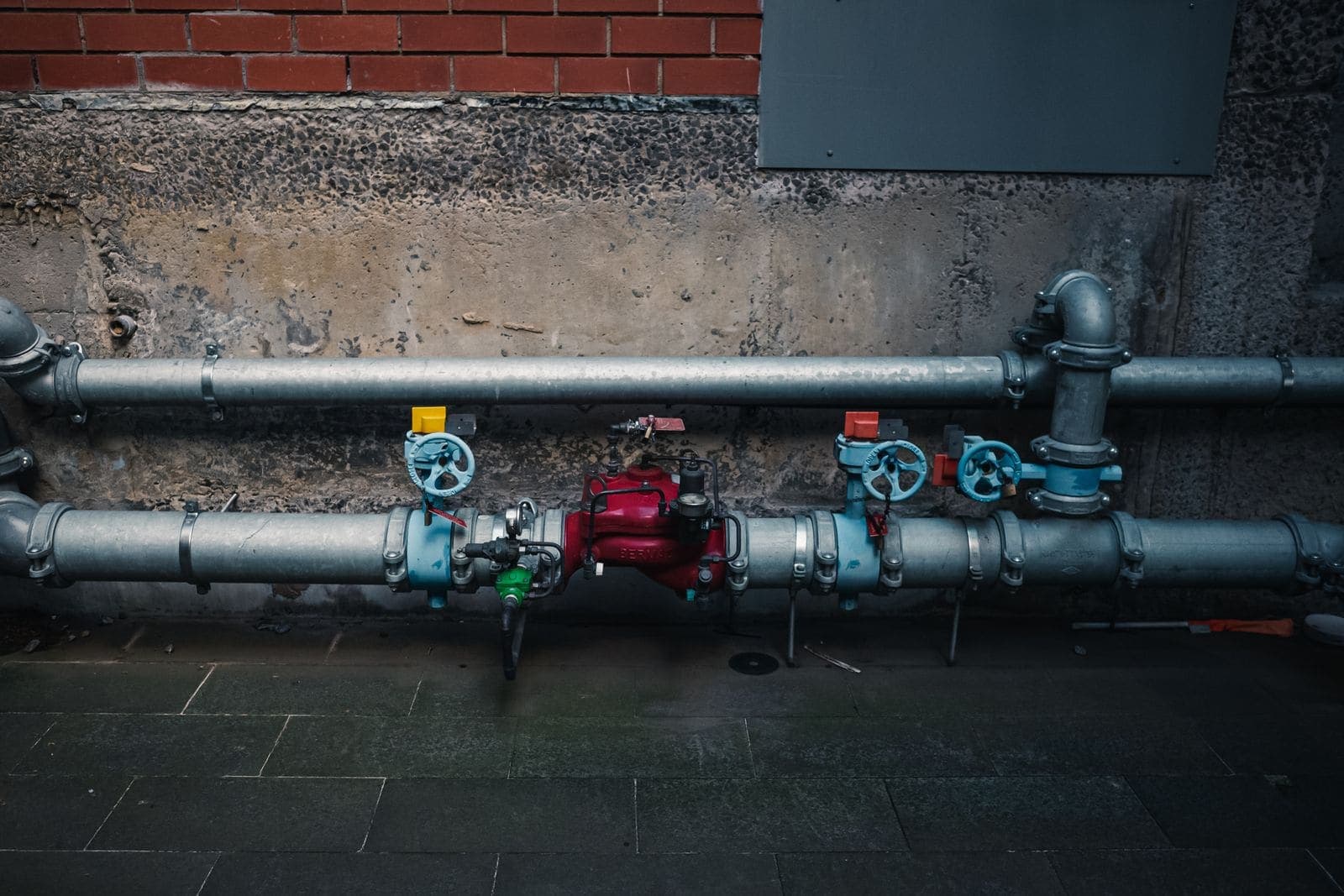 Water pipes and shutoff valves on a wall